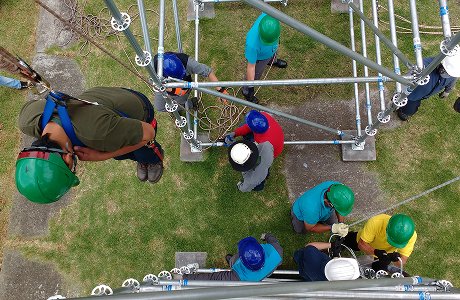 Equipo de rescatistas trabajando en estructura de andamios vista desde arriba